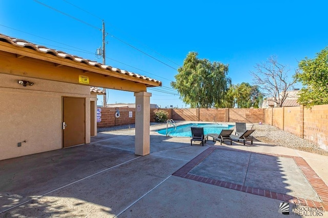 view of swimming pool with a fenced backyard, a fenced in pool, and a patio