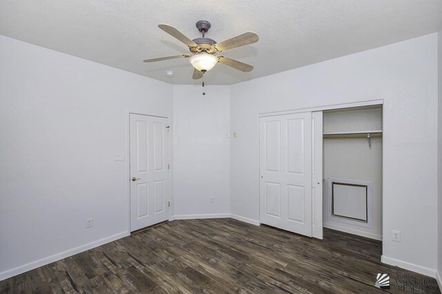 unfurnished bedroom with ceiling fan, dark hardwood / wood-style floors, and a closet