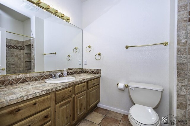 bathroom with decorative backsplash, walk in shower, vanity, tile patterned flooring, and toilet