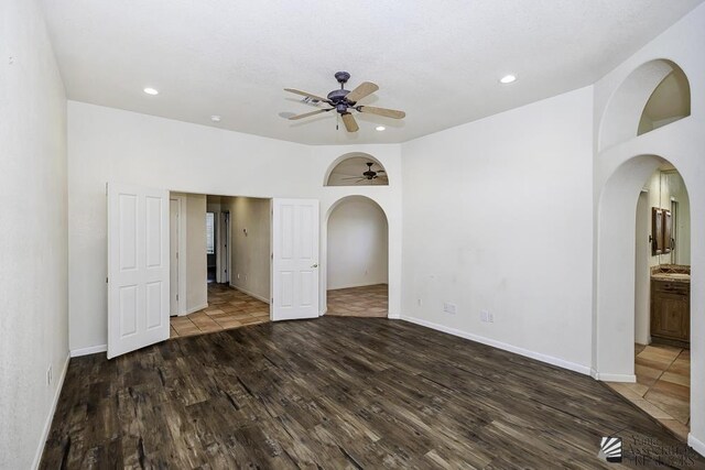 spare room featuring ceiling fan and dark hardwood / wood-style flooring