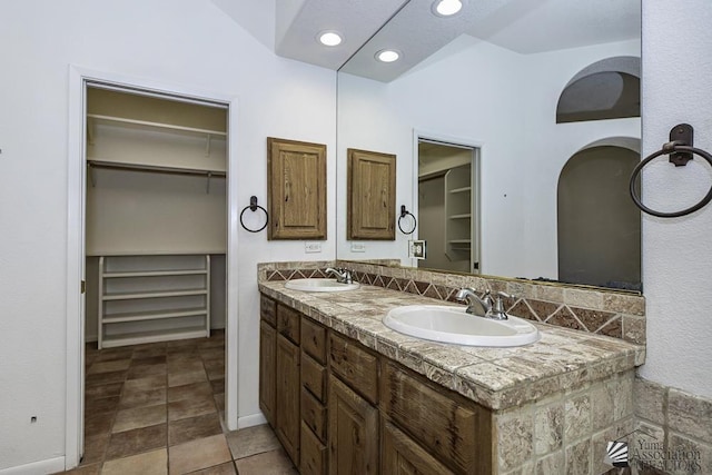 bathroom featuring vanity and vaulted ceiling