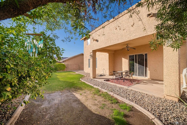 view of yard with ceiling fan and a patio