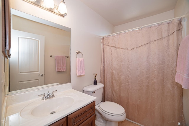 bathroom with vanity, toilet, and walk in shower