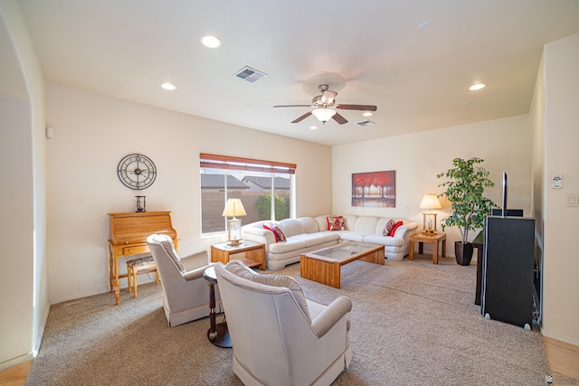 living room with light carpet and ceiling fan