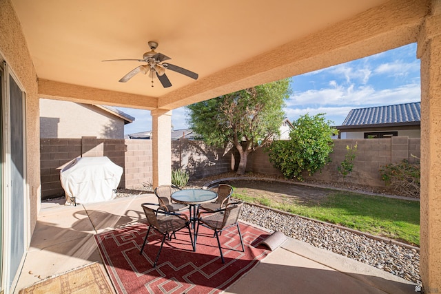 view of patio with ceiling fan and grilling area