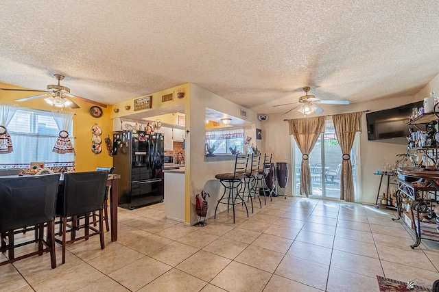 dining room featuring a ceiling fan, light tile patterned flooring, and visible vents