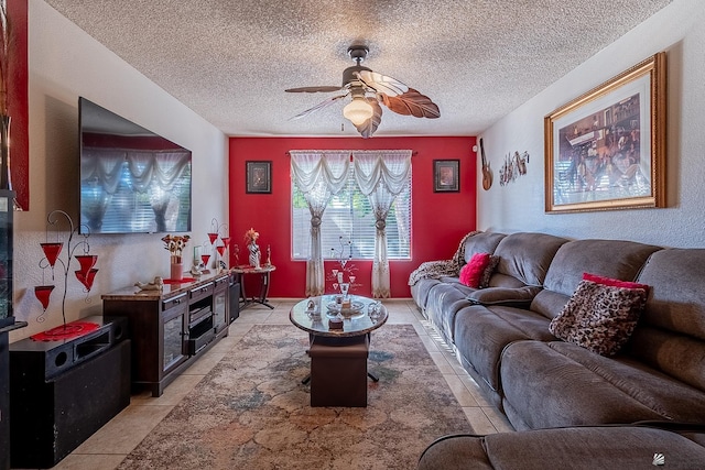 living room with ceiling fan, a textured ceiling, and light tile patterned floors