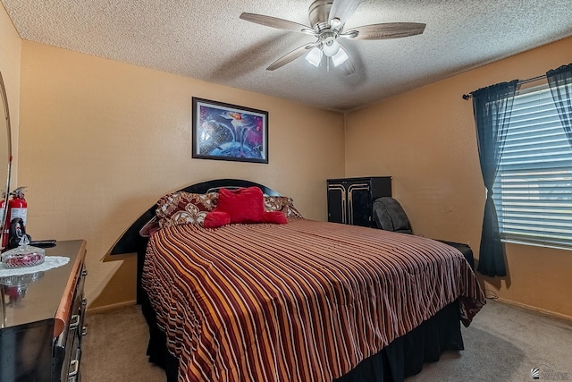 bedroom with a textured ceiling, ceiling fan, baseboards, and light colored carpet