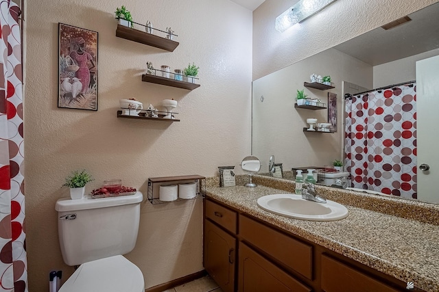 bathroom featuring toilet, visible vents, and vanity