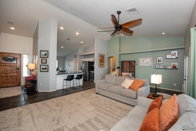 living area with visible vents, ceiling fan, dark carpet, recessed lighting, and arched walkways