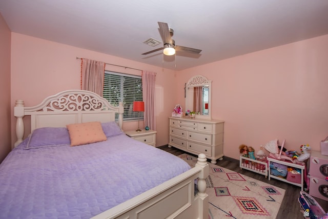 bedroom featuring visible vents, wood finished floors, and a ceiling fan