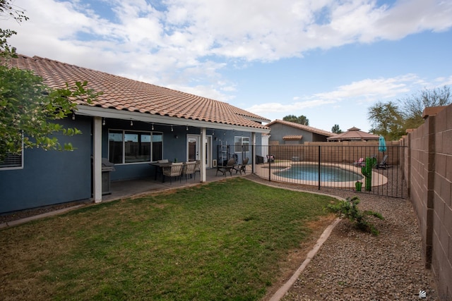 view of yard featuring a fenced in pool, a fenced backyard, and a patio area