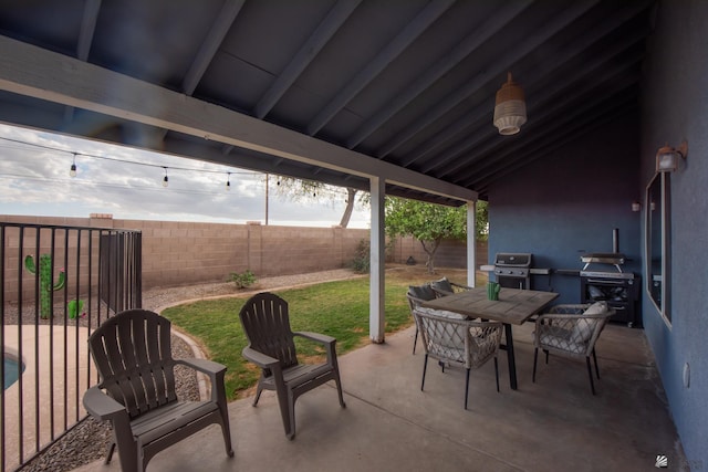 view of patio with outdoor dining area, a grill, and a fenced backyard