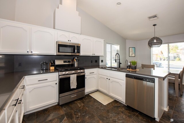 kitchen with visible vents, a peninsula, a sink, stainless steel appliances, and white cabinetry