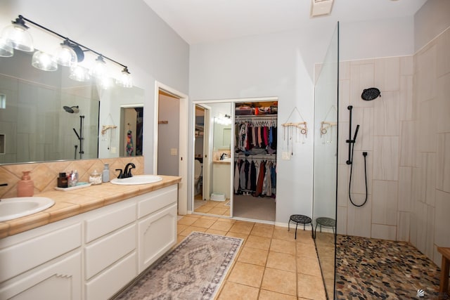 bathroom with tile patterned floors, walk in shower, double vanity, and a sink