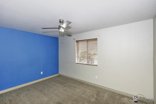 empty room with a ceiling fan, carpet, baseboards, and a textured ceiling