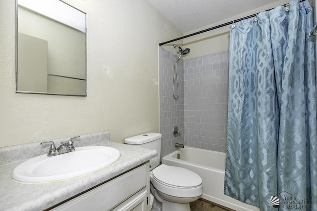 bathroom featuring toilet, shower / bath combo, and vanity