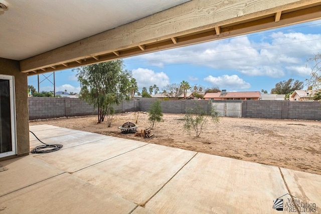 view of patio / terrace featuring an outdoor fire pit and a fenced backyard