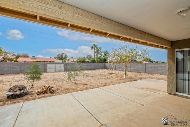 view of patio / terrace featuring an outdoor fire pit and a fenced backyard