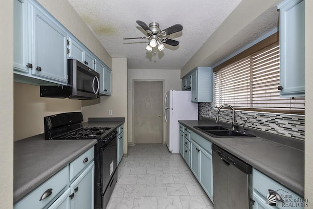 kitchen with ceiling fan, a textured ceiling, blue cabinets, stainless steel appliances, and a sink