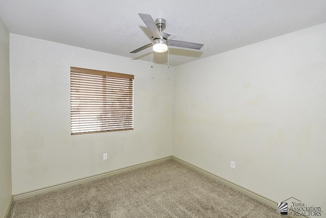 spare room featuring a ceiling fan, carpet flooring, a textured ceiling, and baseboards