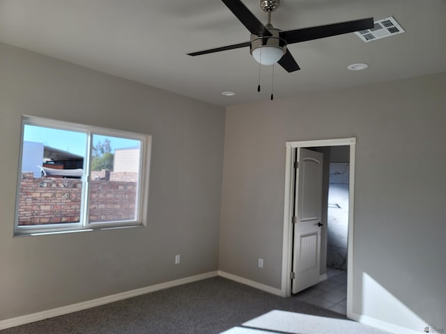 unfurnished bedroom with carpet, ensuite bathroom, and ceiling fan