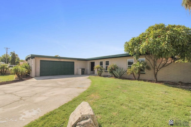 ranch-style home featuring a garage and a front lawn