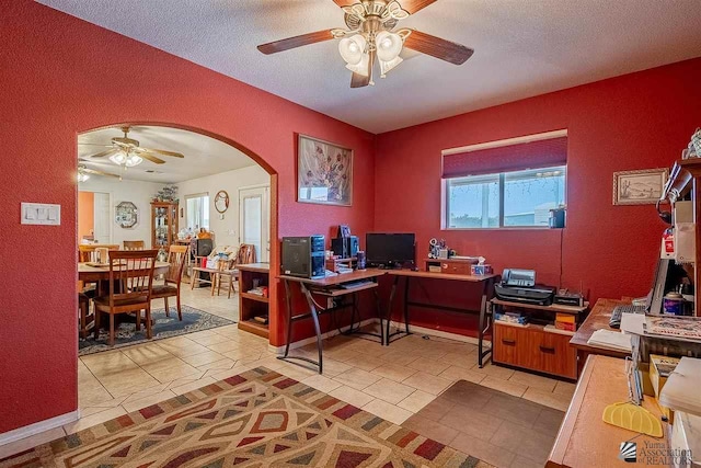 office space featuring a healthy amount of sunlight, light tile patterned floors, and a textured ceiling