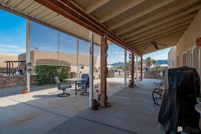 view of patio / terrace with a mountain view and ceiling fan