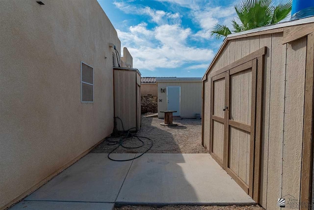 view of patio with a storage shed