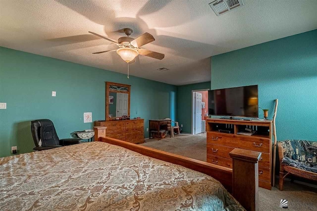 carpeted bedroom featuring ceiling fan and a textured ceiling