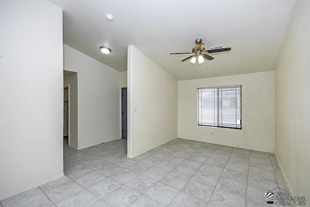 empty room featuring ceiling fan and vaulted ceiling