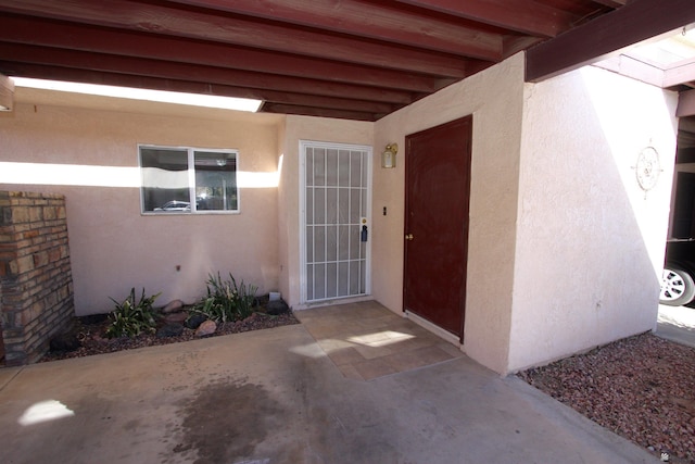 view of exterior entry featuring a patio