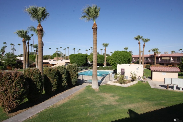 view of swimming pool with a lawn