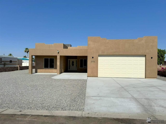 southwest-style home featuring a garage