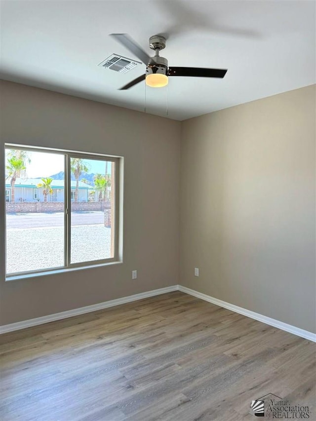 empty room featuring ceiling fan and light wood-type flooring