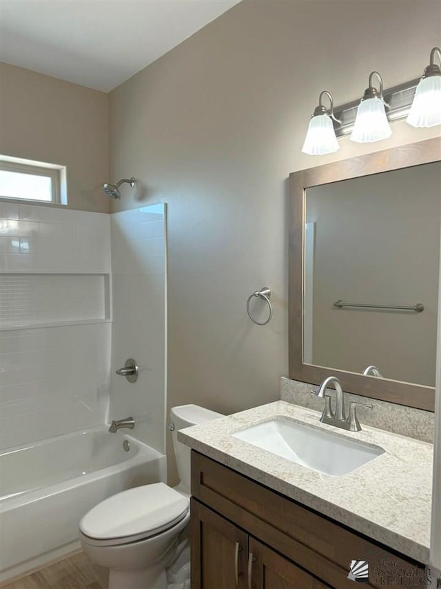 full bathroom featuring shower / bath combination, vanity, and toilet