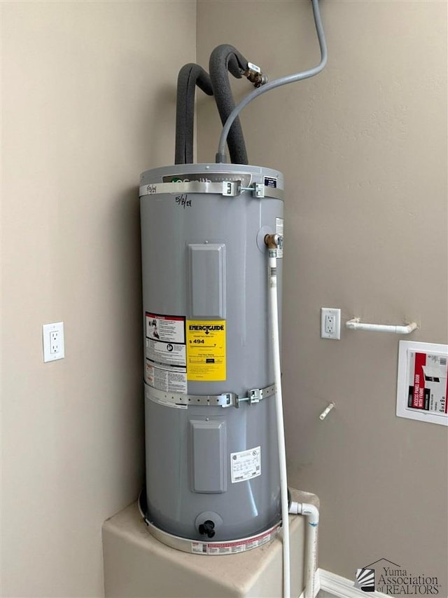 utility room with water heater