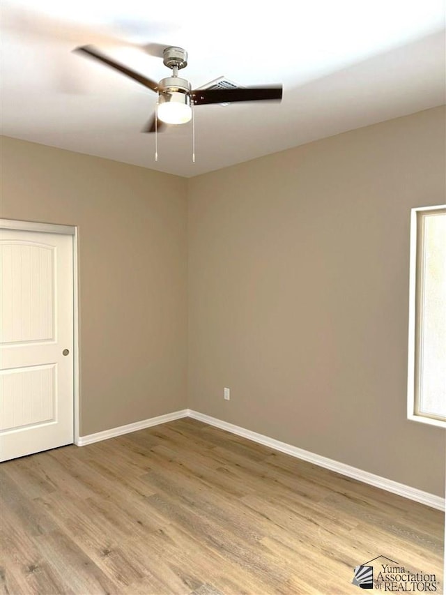 empty room with wood-type flooring and ceiling fan