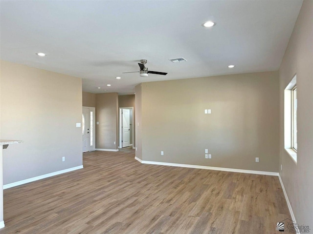 empty room featuring ceiling fan and light hardwood / wood-style floors