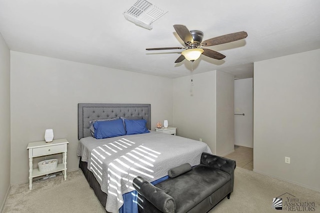 bedroom with ceiling fan and light carpet