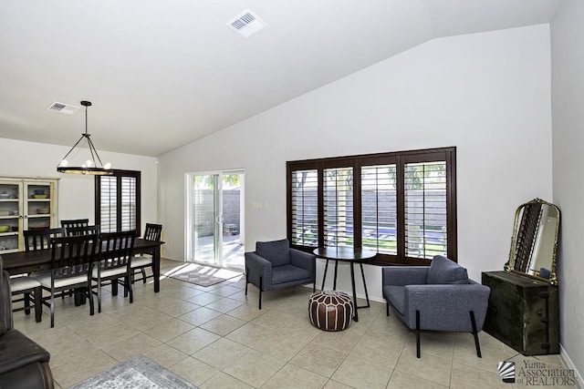 tiled living room featuring lofted ceiling and an inviting chandelier