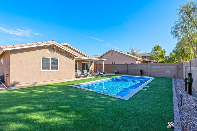 view of pool with a yard and a patio