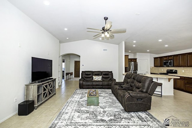 tiled living room featuring vaulted ceiling and ceiling fan