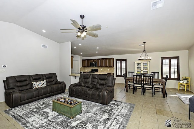 living room featuring light tile patterned floors, plenty of natural light, and lofted ceiling