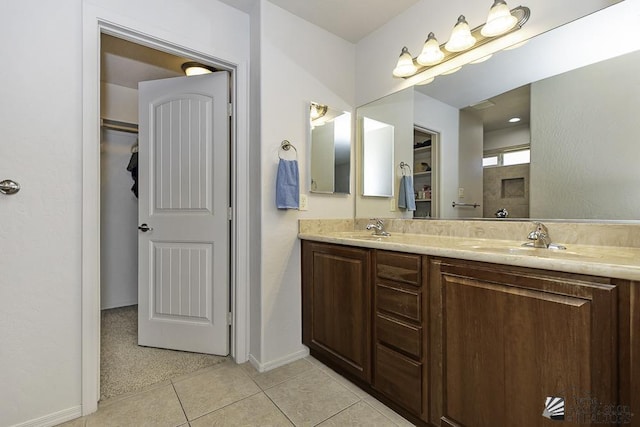 bathroom with tile patterned flooring and vanity