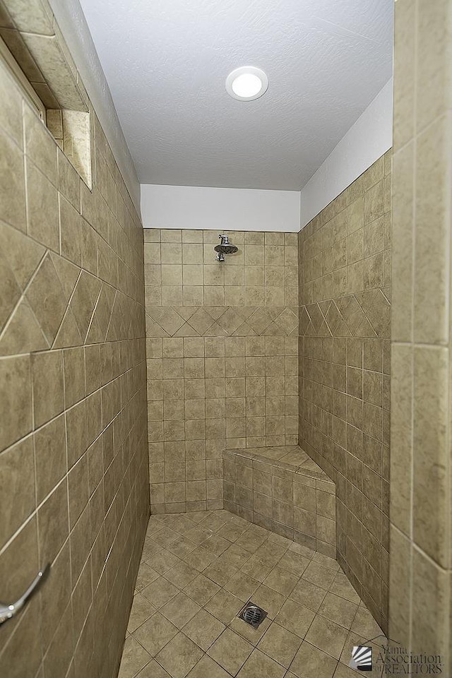 bathroom with a tile shower