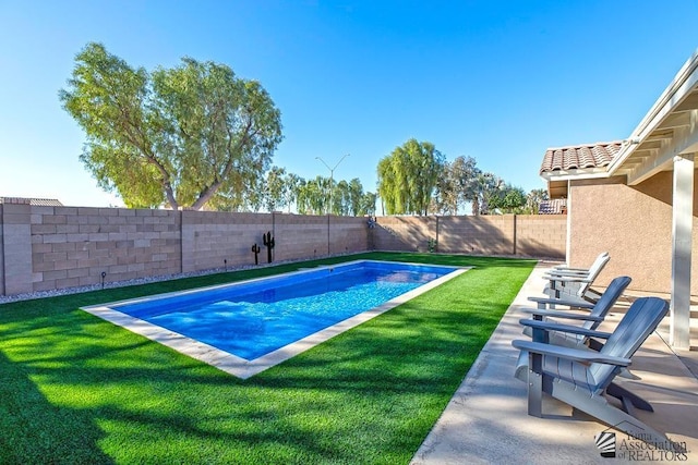 view of pool with a lawn