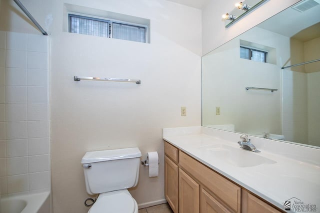 full bathroom featuring vanity, bathing tub / shower combination, and toilet