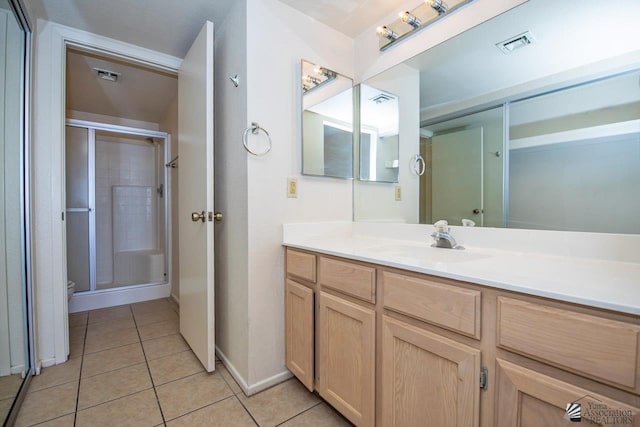 bathroom featuring vanity, tile patterned floors, toilet, and walk in shower